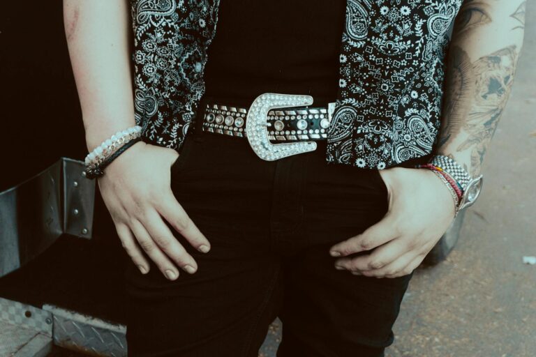 Close-up of a stylish bandana shirt and studded belt, showcasing modern fashion.
