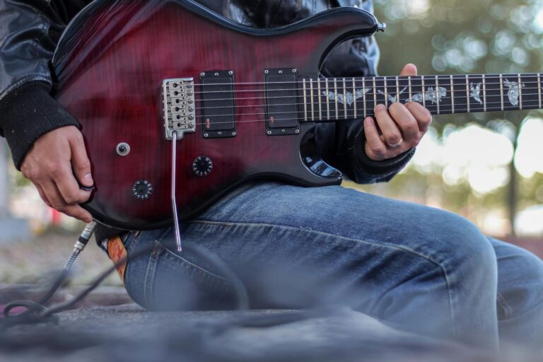 Close-up of a musician playing an electric guitar outdoors in Santiago de Querétaro, Mexico.