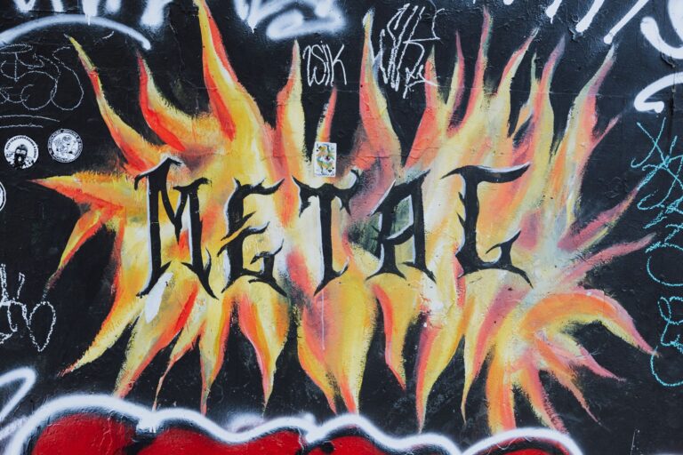 A dynamic street art mural with flaming design and bold text on urban walls.