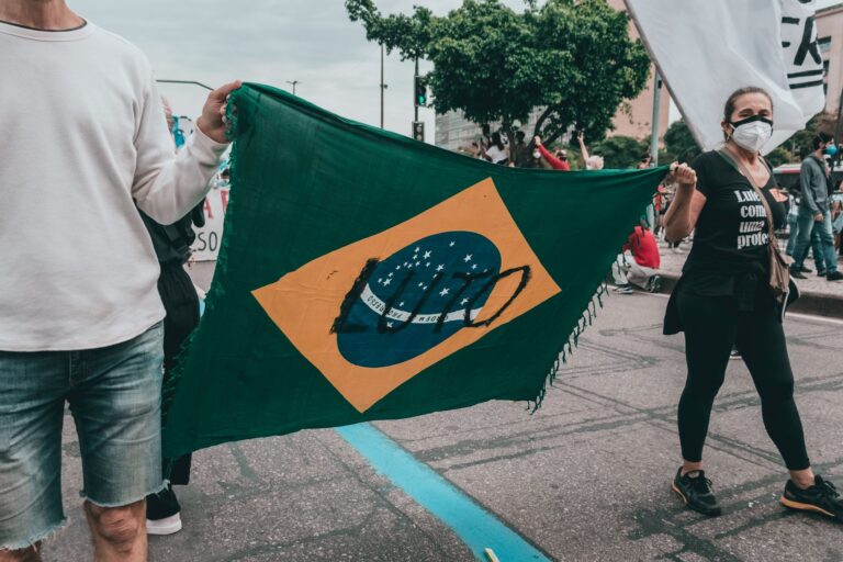 A group of protesters in Rio de Janeiro holding a Brazilian flag during a demonstration.