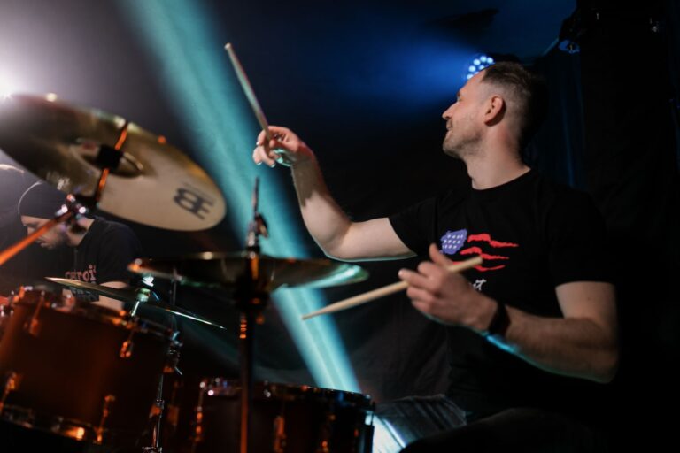 Dynamic image of a drummer playing passionately during a live rock concert.