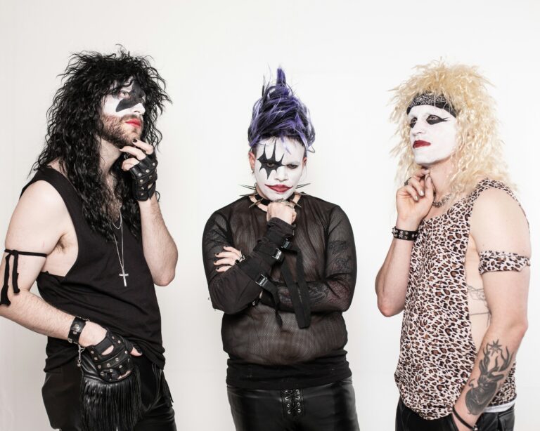 a group of three men with makeup on their faces